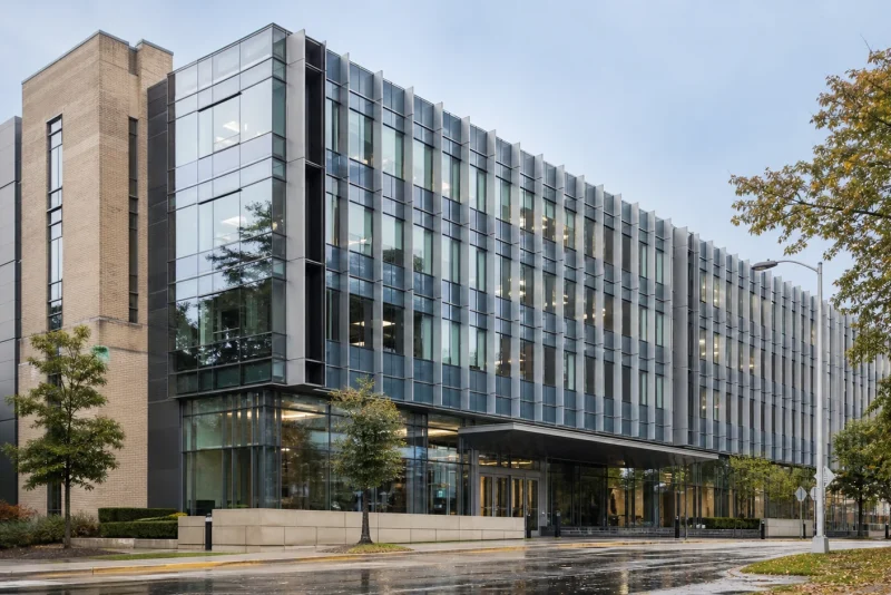 Completed institutional facade renovation integrating retained masonry with a new high-performance curtain wall