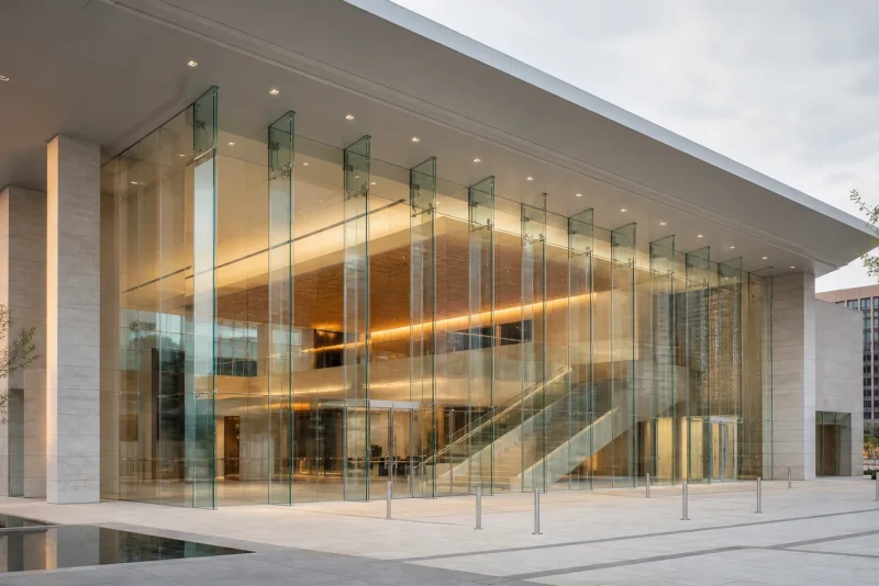 International cultural foyer with large-format structural glazing, glass fins and minimal sightlines
